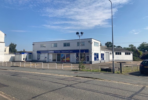 Site of former car showroom with permission for 55 apartments up for sale